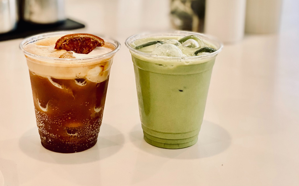 An iced coffee and an iced matcha latte in plastic cups.