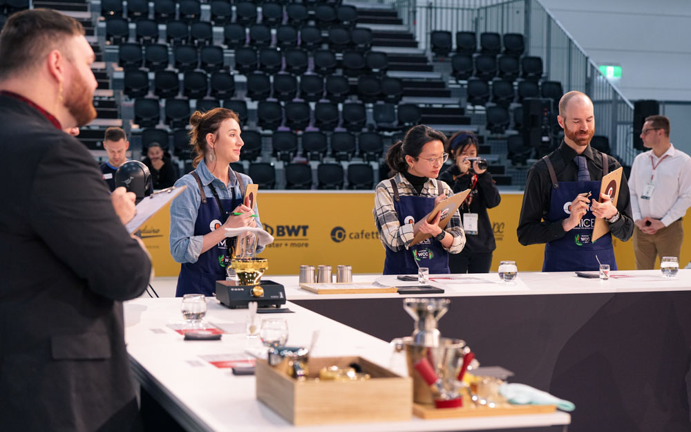 Judges watch a competitor at the World Barista Championship.